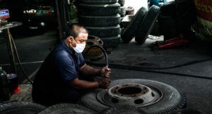 photo of a mechanic repairing auto wheels